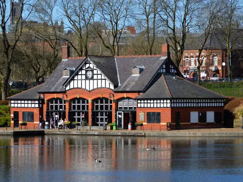 The black-and-white timbered boathouse beside the boating lake in Alexandra Park, Oldham
