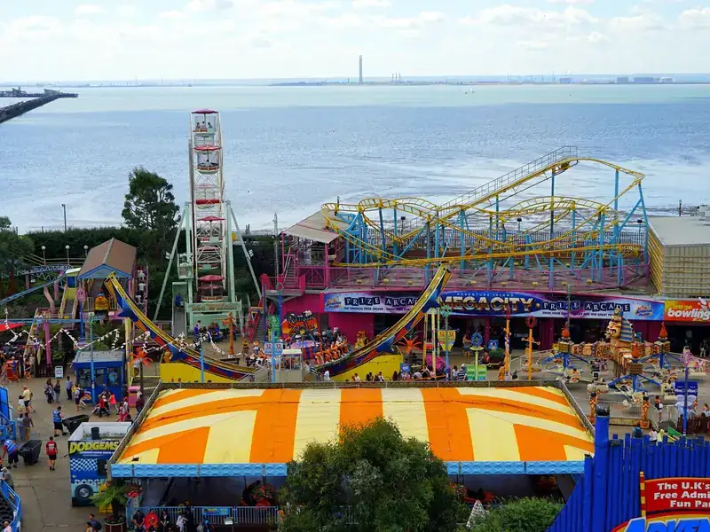 Adventure Island fairground and Southend Pier stretching out into the Thames Estuary at Southend-on-Sea